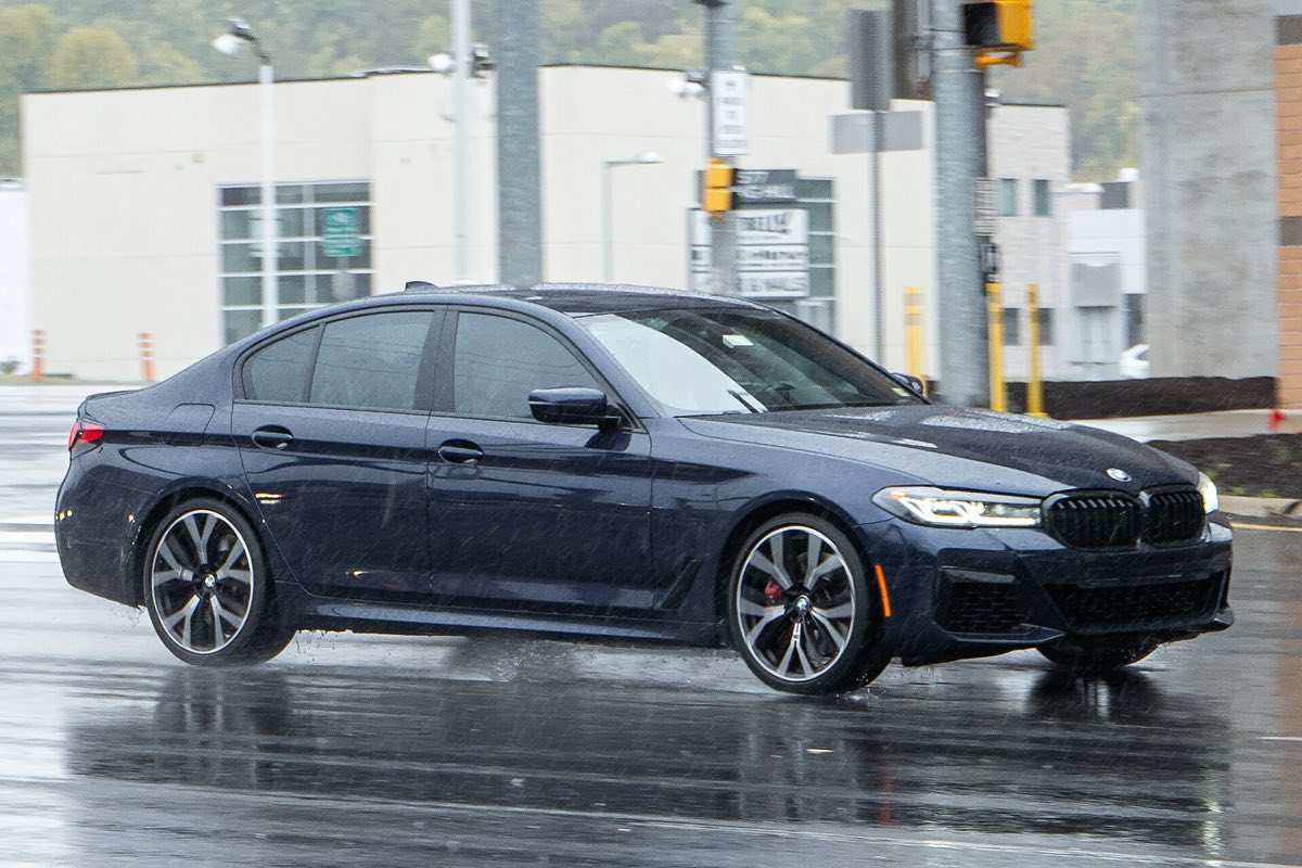 Front three-quarter view of a dark blue 2021 BMW 540i xDrive sedan