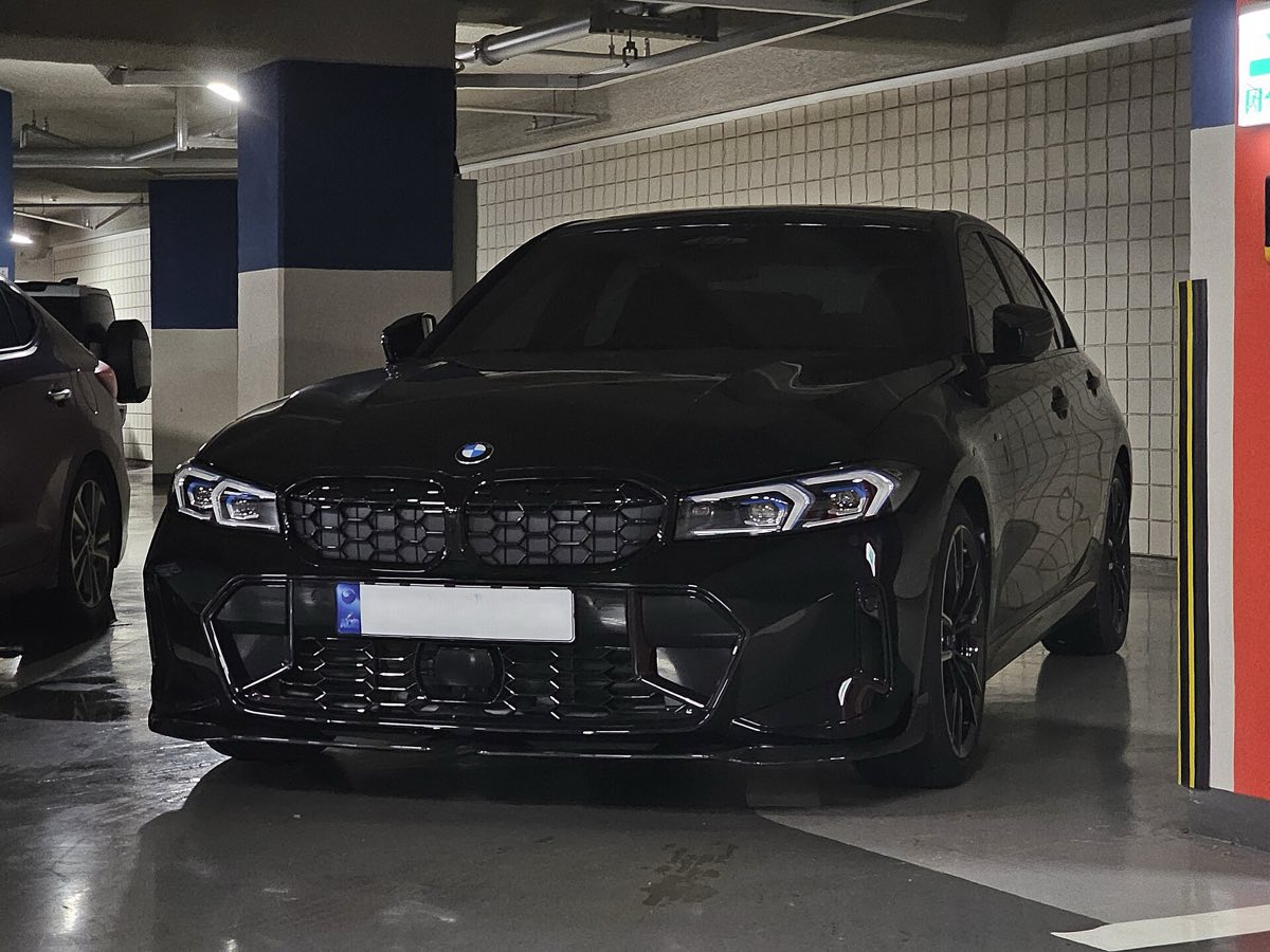 Front three-quarter view of a black 2023 BMW M340i sedan